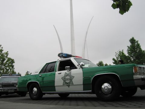 1991 Ford Crown Victoria - A 1991 Ford Crown Victoria Sheriff's car is parked outdoors, with a distinctive monument in the background.