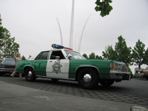 1991 Ford Crown Victoria - Sheriff car with light bar parked outdoors, with another vehicle and the Air Force Memorial visible.