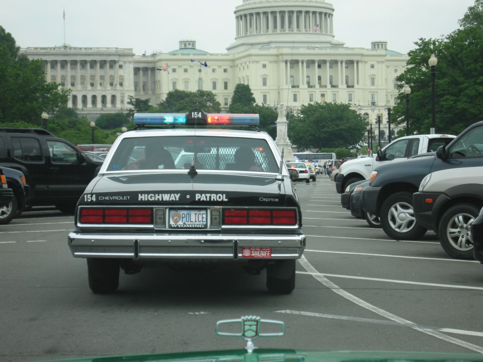 Rear of black Chevrolet Caprice Highway Patrol car parked before the U.S. Capitol