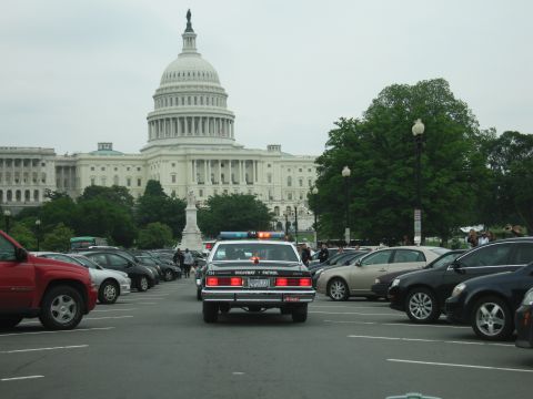 1991 Ford Crown Victoria - A highway patrol car is parked in a lot with the US Capitol building in the background.