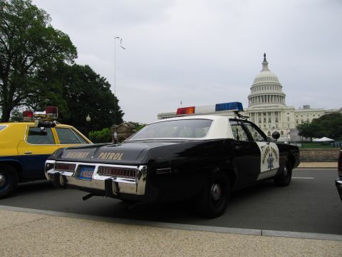 1991 Ford Crown Victoria - Two police cars are parked with the US Capitol building in the background.