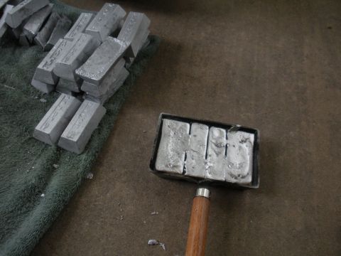 1996 Ford Bronco - Lead ingots are stacked on a towel, with a mold containing more ingots nearby.
