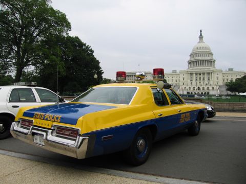1991 Ford Crown Victoria - A vintage New York State Police car, likely from the 1970s, is parked with the U.S. Capitol building visible behind it.