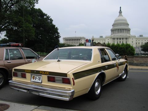 1991 Ford Crown Victoria - Two police cars are parked with the US Capitol building visible behind them.