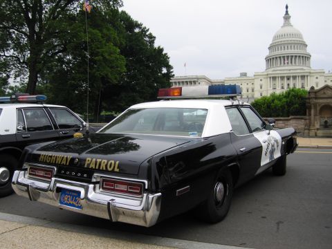 1991 Ford Crown Victoria - A Dodge police car with "HIGHWAY PATROL" text is parked in front of the Capitol Building.