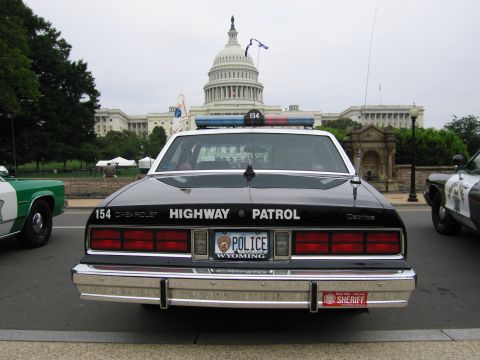 1991 Ford Crown Victoria - A Chevrolet police car is parked in front of the Capitol building, with another police vehicle visible to the side.