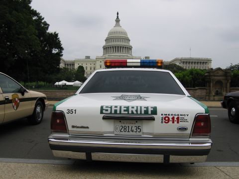 1991 Ford Crown Victoria - A 1991 Ford Crown Victoria Sheriff's car is parked in front of the U.S. Capitol building, with another vehicle visible to the left.