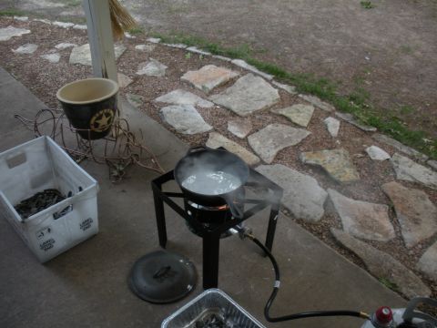 1996 Ford Bronco - An outdoor cooking scene features a pot of boiling water on a propane burner next to a crate of seafood.