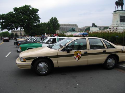 1991 Ford Crown Victoria - Maryland State Police Crown Victoria, part of a line of vehicles, with the Washington Monument visible.