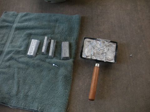 1996 Ford Bronco - Lead ingots and a mold are laid out on a towel and concrete floor.