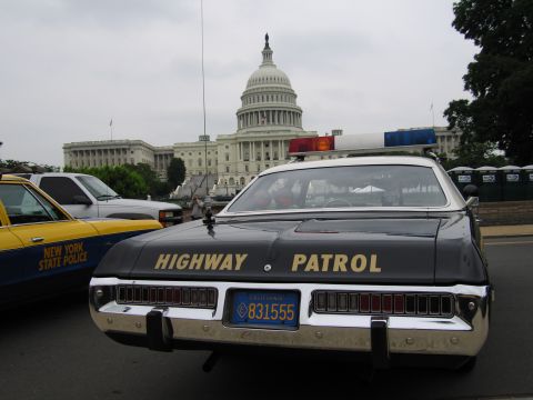 1991 Ford Crown Victoria - A black Highway Patrol car is parked in front of the Capitol Building, with a New York State Police car visible to the left.