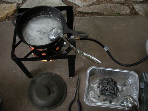 1996 Ford Bronco - Setup for melting and casting metal, including a pot, burner, and tools.