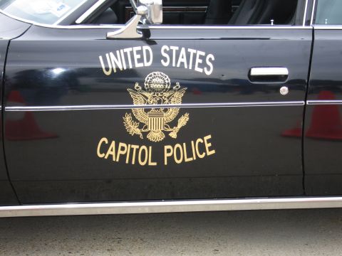 1991 Ford Crown Victoria - The side of a black vehicle displays "UNITED STATES CAPITOL POLICE" in gold lettering with the Great Seal of the United States.