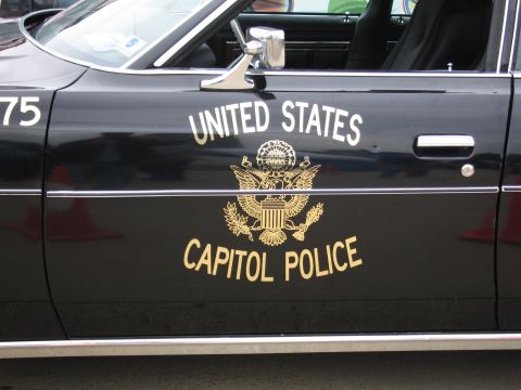 1991 Ford Crown Victoria - A black police car with "United States Capitol Police" text and emblem on its side door.