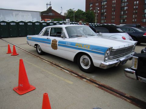 1991 Ford Crown Victoria - This vintage police car has '601' and 'CUSTOM' text visible on its side.