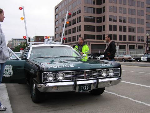 1991 Ford Crown Victoria - A vintage police car with "1745 NYC POLICE" license plate is parked on a street.