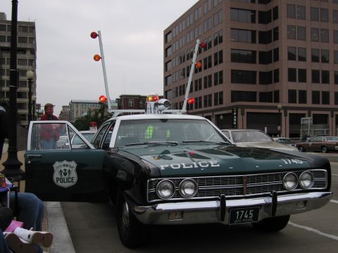1991 Ford Crown Victoria - This 1969 Ford police car features a distinctive light bar and "POLICE" lettering on the hood.