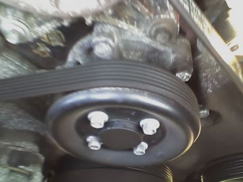 2001 Ford Crown Victoria - This image shows a close-up view of a vehicle's engine belt and pulley.