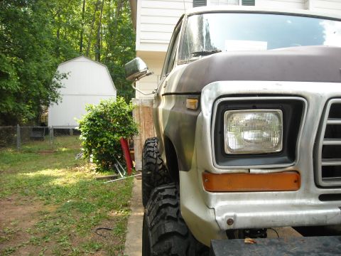 1979 Ford F-150 - Front corner view of a 1979 Ford F-150 pickup truck with prominent off-road tires.