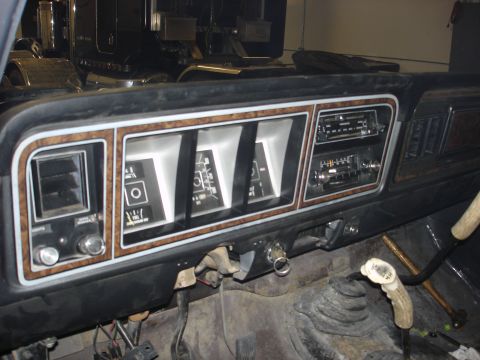 1979 Ford F-250 - The interior of a vehicle shows the dashboard with its gauges, radio, and a unique antler gear shift knob.