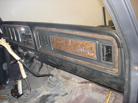 1979 Ford F-250 - The interior dashboard of a 1979 Ford F-250 shows woodgrain trim and a "RANGER XLT" badge.