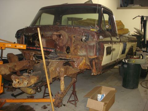 1979 Ford F-250 - This 1979 Ford F-250 is undergoing extensive restoration, with its front end completely disassembled and showing significant rust.