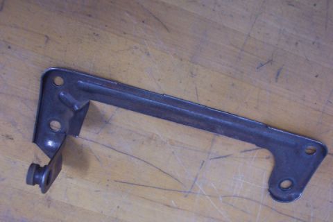 1972 Ford Ranchero - A metal bracket with a bolt is shown against a wooden background. The registry label indicates it is from a 1972 Ford Ranchero.