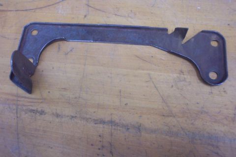 1972 Ford Ranchero - A single metal bracket is shown on a wooden surface.