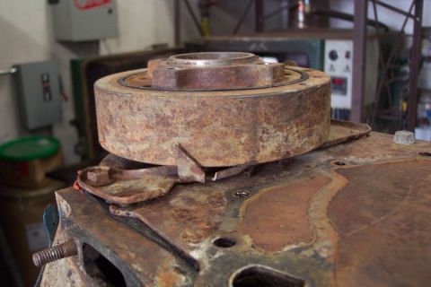 1972 Ford Ranchero - A heavily rusted engine pulley assembly is bolted to an engine block, with other machinery in the background.