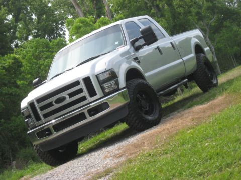 2008 Ford F-250 - Silver 2008 Ford F-250 pickup truck with large tires and chrome grille.