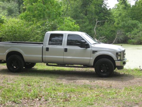 2008 Ford F-250 - Side view of a silver 2008 Ford F-250 crew cab pickup truck parked outdoors.