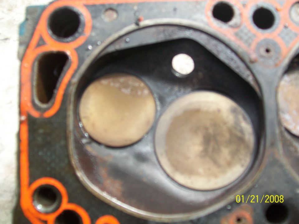 Engine cylinder head showing two valves and orange gasket material. Date stamp '01/21/2008' and 'SUPERMOTORS' logo visible