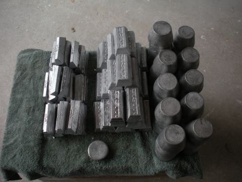 1996 Ford Bronco - A collection of lead ingots and casting molds are neatly arranged on a green cloth, ready for use.
