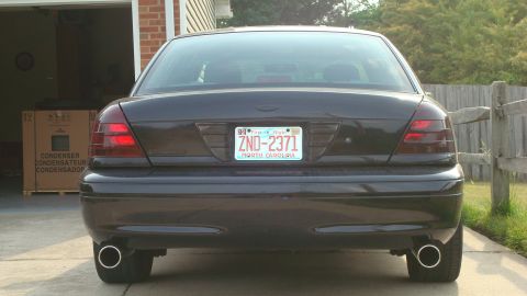 2004 Ford Crown Victoria - Rear view of a 2004 Ford Crown Victoria, showing its taillights and dual exhaust tips.