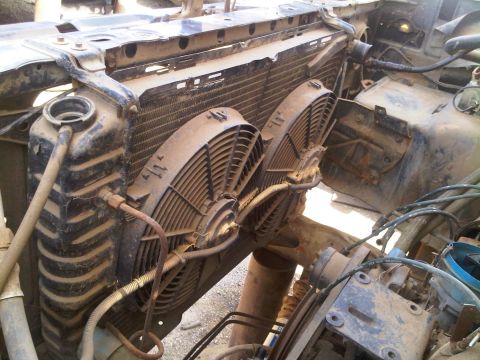 1986 Ford Bronco - Close-up view of a vehicle's radiator and cooling fans, showing engine components and wiring.