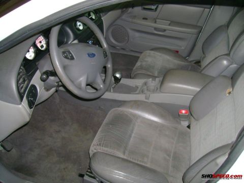 1993 Ford Taurus - The interior of a car, likely a Ford, shows the dashboard, steering wheel, and seats.