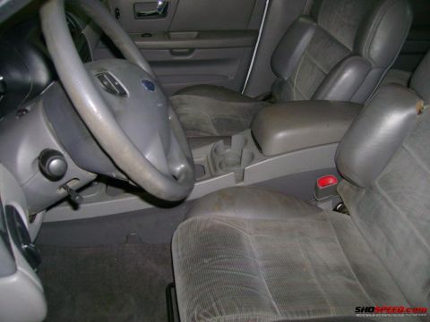 1993 Ford Taurus - Interior view of a car, showing the driver's seat, steering wheel, and center console.