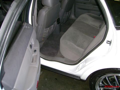 1993 Ford Taurus - Interior view of a 1993 Ford Taurus, focusing on the rear seating area and door panel.
