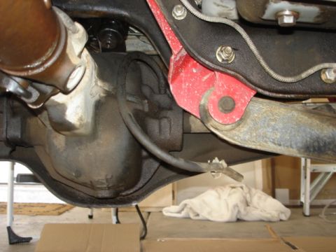 1992 Ford Bronco - Close-up view of the rear axle and suspension components of a vehicle.