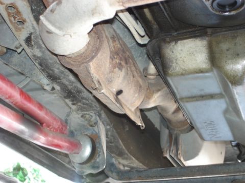 1992 Ford Bronco - Undercarriage view showing exhaust components and transmission pan with visible 'Ford' marking.