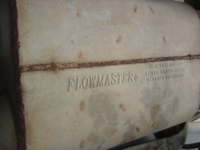Close-up of a Flowmaster muffler case stamped with the brand name and patent numbers