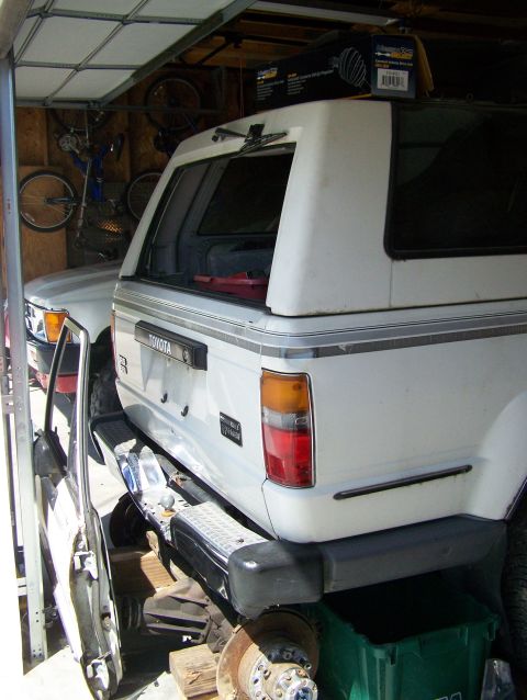 1988 Suzuki Samurai - This 1988 Toyota 4Runner is parked in a garage, partially obscured by another vehicle.