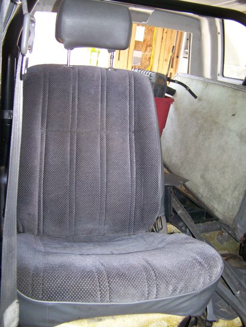 1988 Suzuki Samurai - Interior view of a vehicle's front seat and surrounding cabin area.