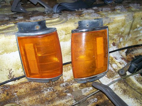1988 Suzuki Samurai - Two amber turn signal lights are shown in a dirty, possibly interior, vehicle space.