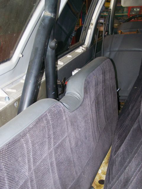 1988 Suzuki Samurai - The interior of a vehicle is visible, with patterned seats and a roll cage.