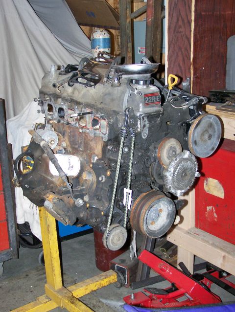 1988 Suzuki Samurai - A 22R-E engine is mounted on an engine stand in a workshop setting.