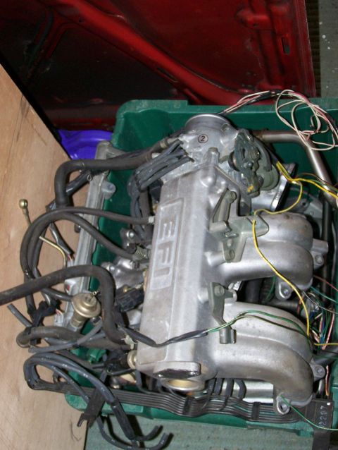 1988 Suzuki Samurai - Engine intake manifold with visible wiring and hoses, likely from a disassembled vehicle.