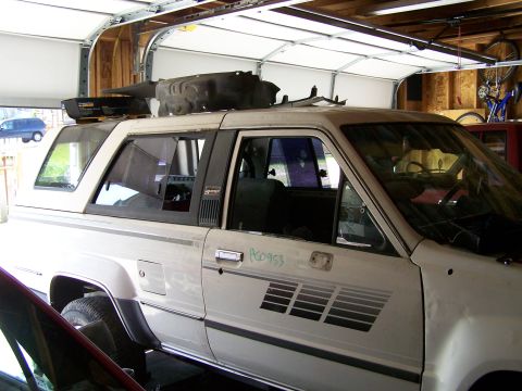 1988 Suzuki Samurai - This 1988 Toyota 4Runner is parked inside a garage with parts loaded on its roof.