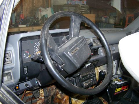 1988 Suzuki Samurai - Interior view of a Toyota vehicle, showing the steering wheel, dashboard, and radio.