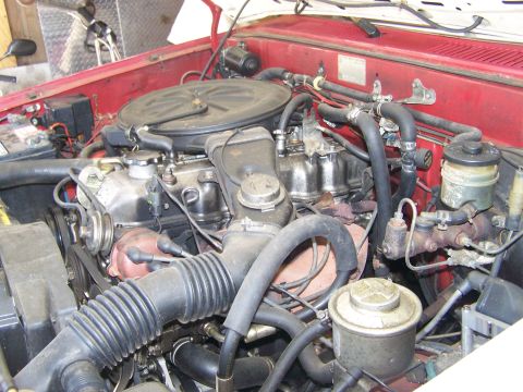 1988 Suzuki Samurai - Close-up view of a vehicle's engine bay, showing various components and hoses.